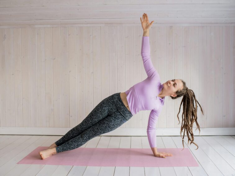 Woman In Pink Long Sleeve Shirt And Gray Leggings Doing Yoga